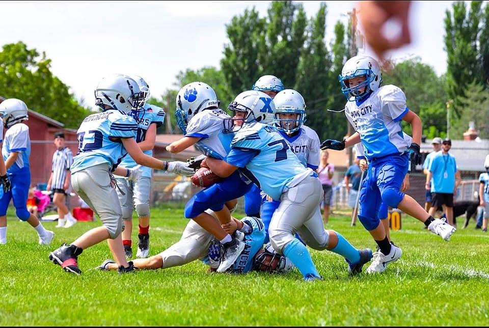 Youth playing tackle football